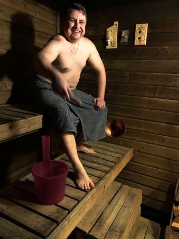A man takes a bath in a sauna.